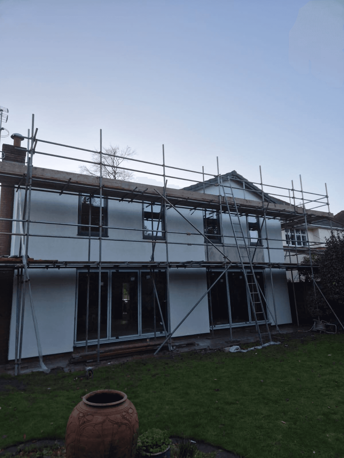 Large property with white render from garden