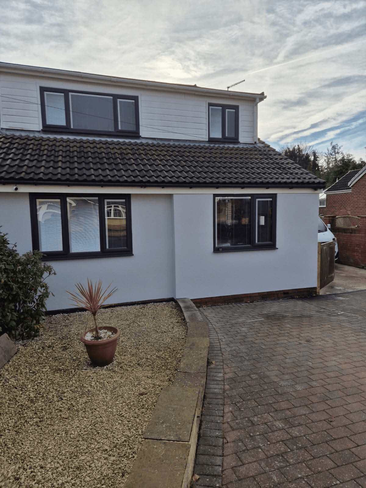 Two-storey semi with white render and dormer